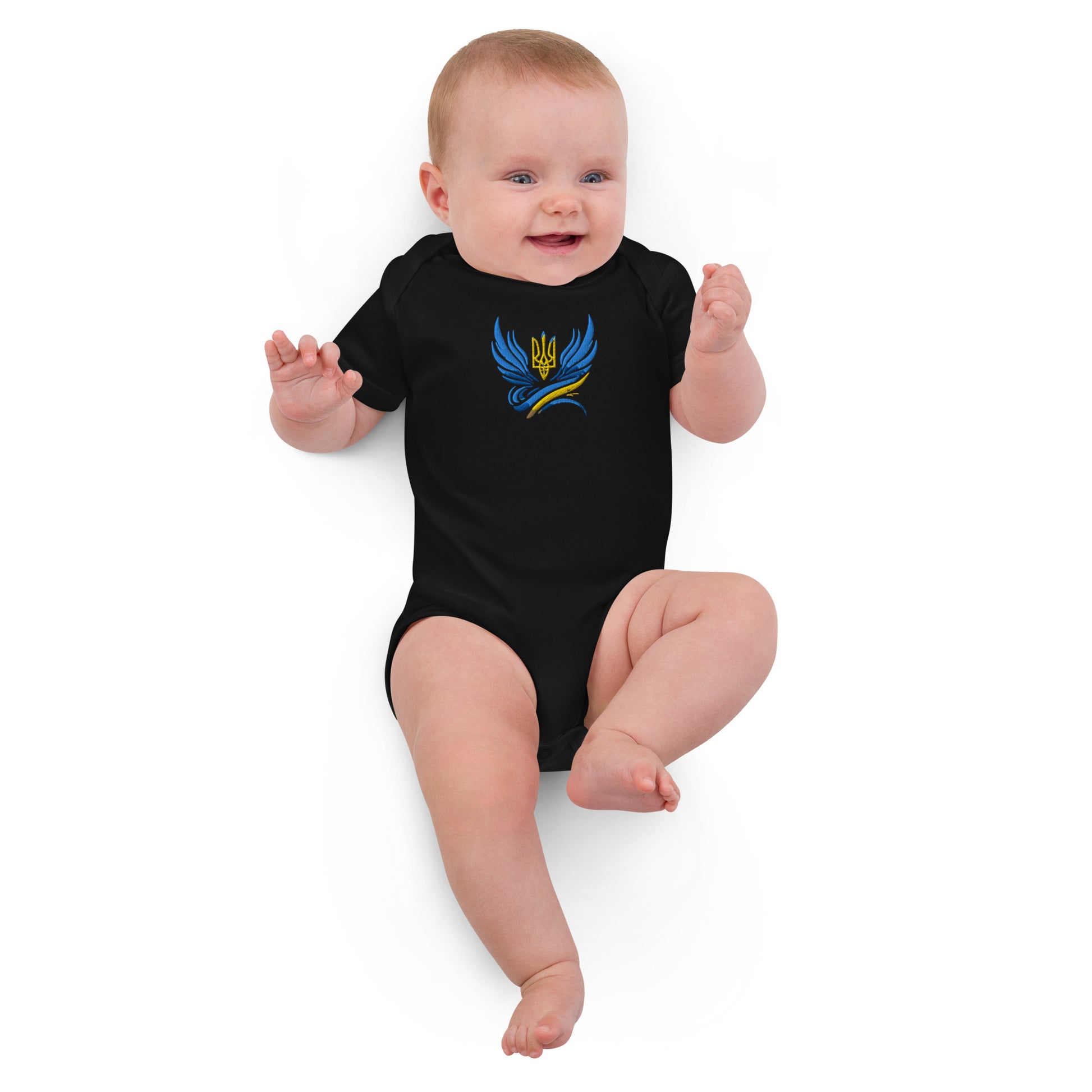 Baby wearing organic cotton bodysuit with Ukrainian Tryzub logo, showcasing comfort and heritage.