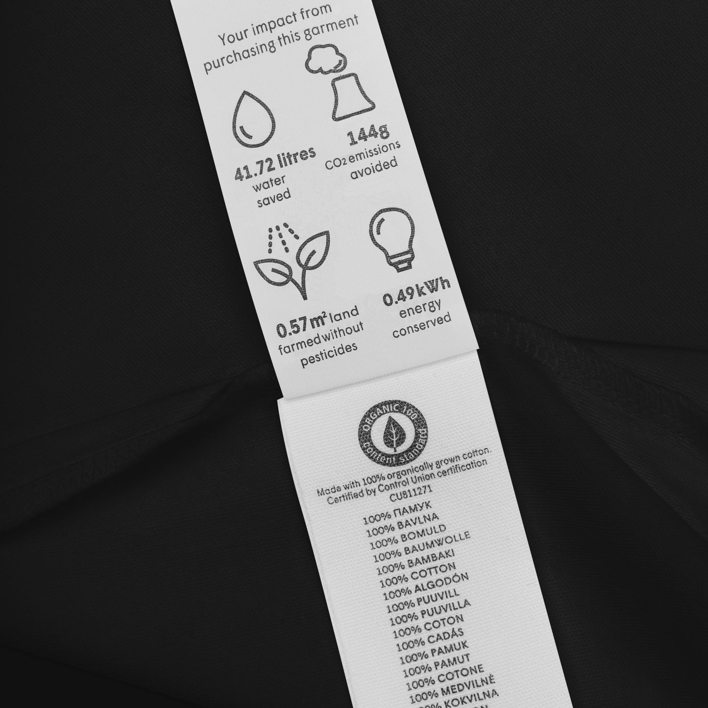 "Organic cotton garment label with sustainability impact, water and energy savings details"