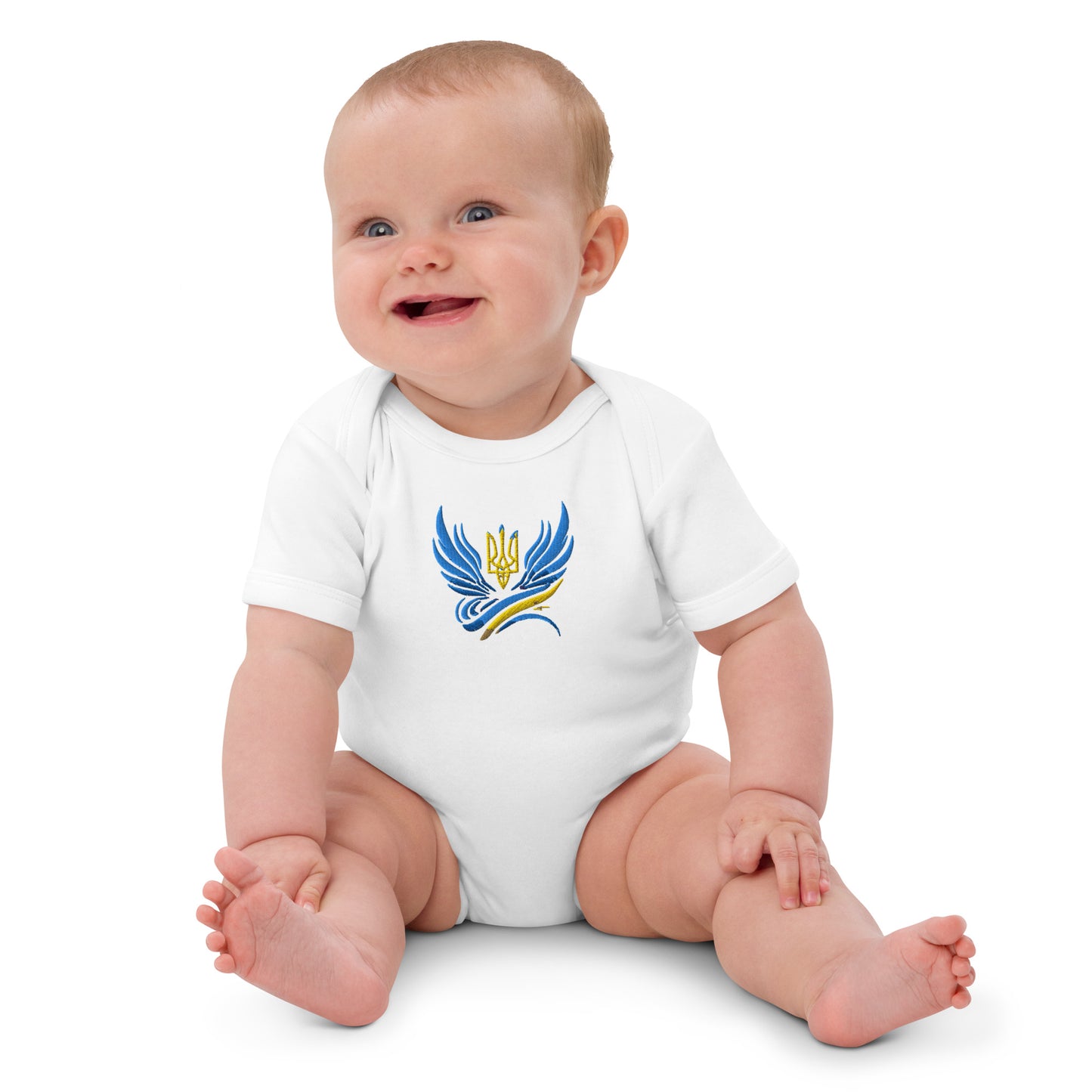 Baby wearing organic cotton bodysuit with Ukrainian Tryzub logo, symbolizing heritage and sustainability.