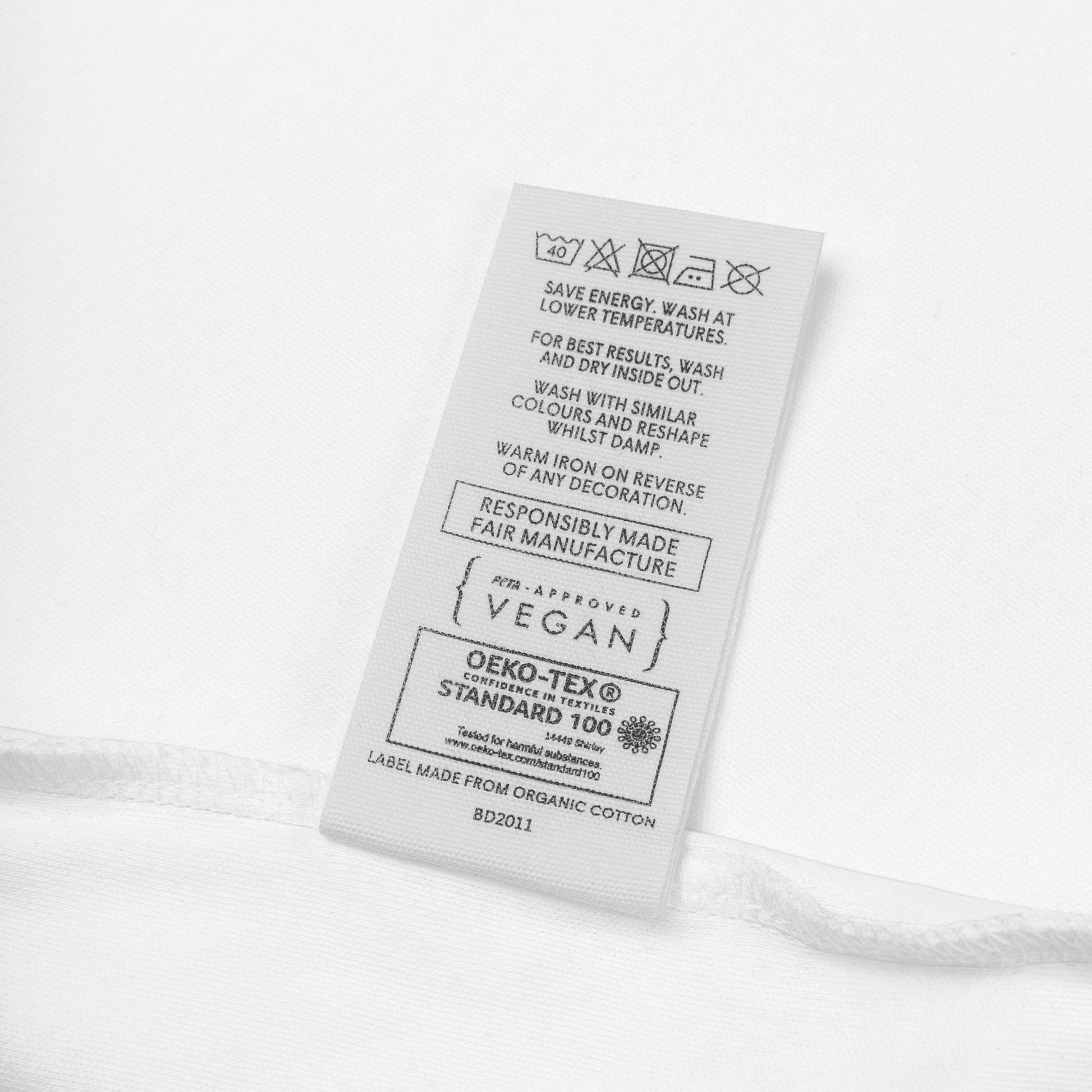 Organic cotton care label with sustainability and vegan certifications.