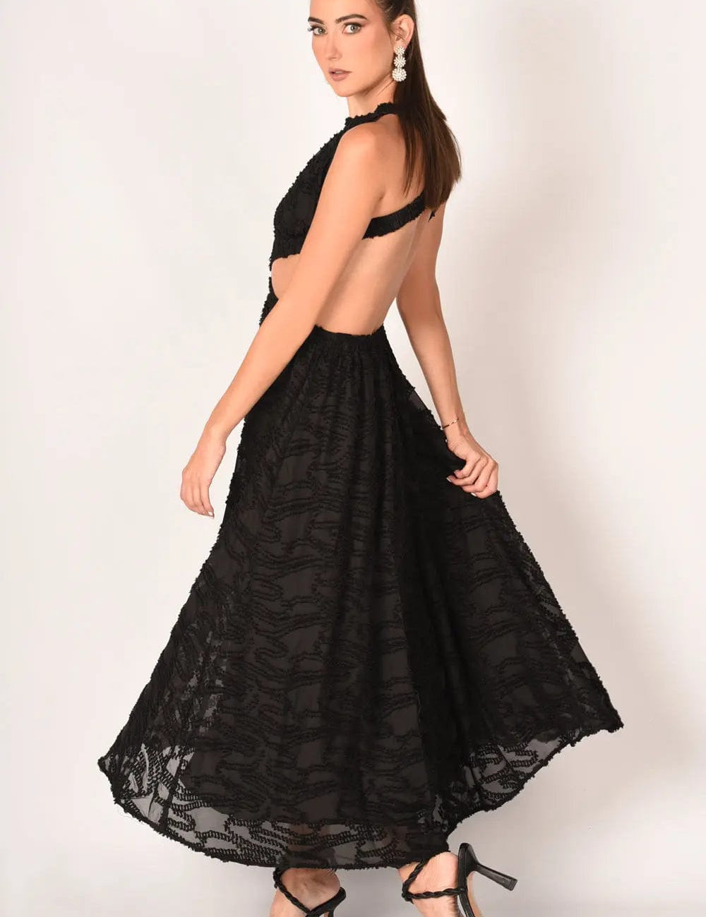 Whispering Jacquard Maxi Dress with open back, textured surface, cinched waist, and elastic straps, ideal for summer occasions.
