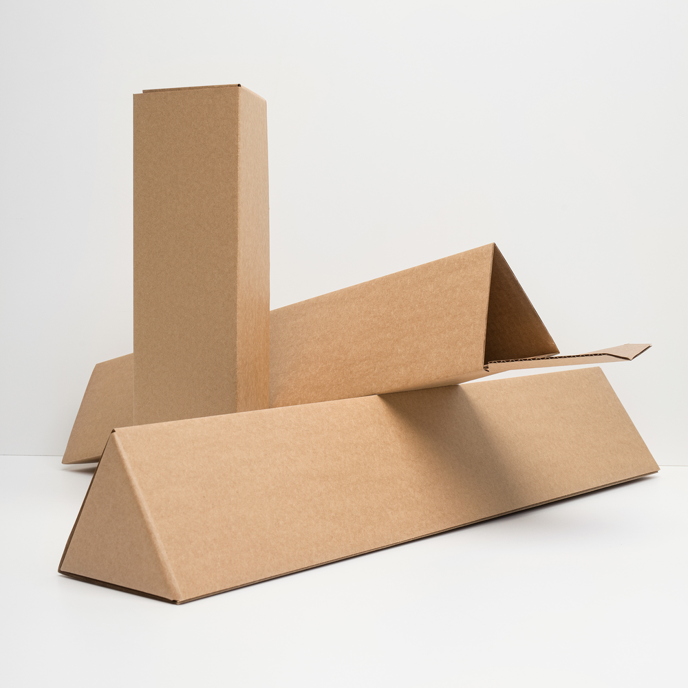 Cardboard packaging boxes in triangular shapes on a white background.