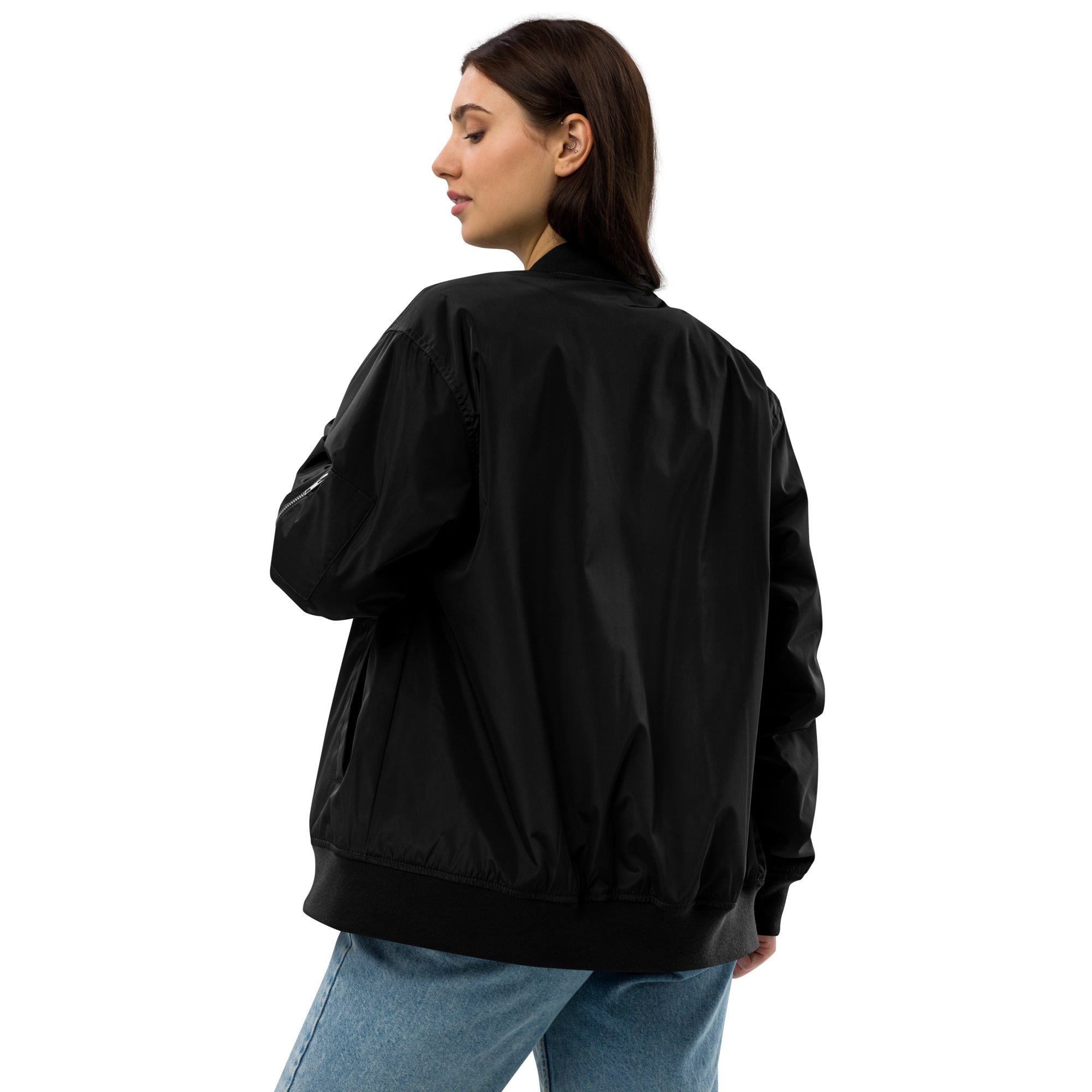Woman wearing a black Ukrainian premium recycled bomber jacket, showcasing eco-friendly fashion with relaxed fit and unisex style.