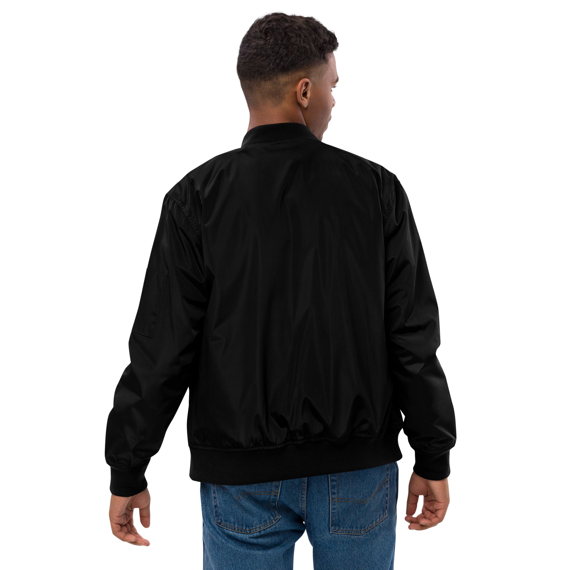 Man wearing black Trizub Collection recycled polyester bomber jacket, back view.