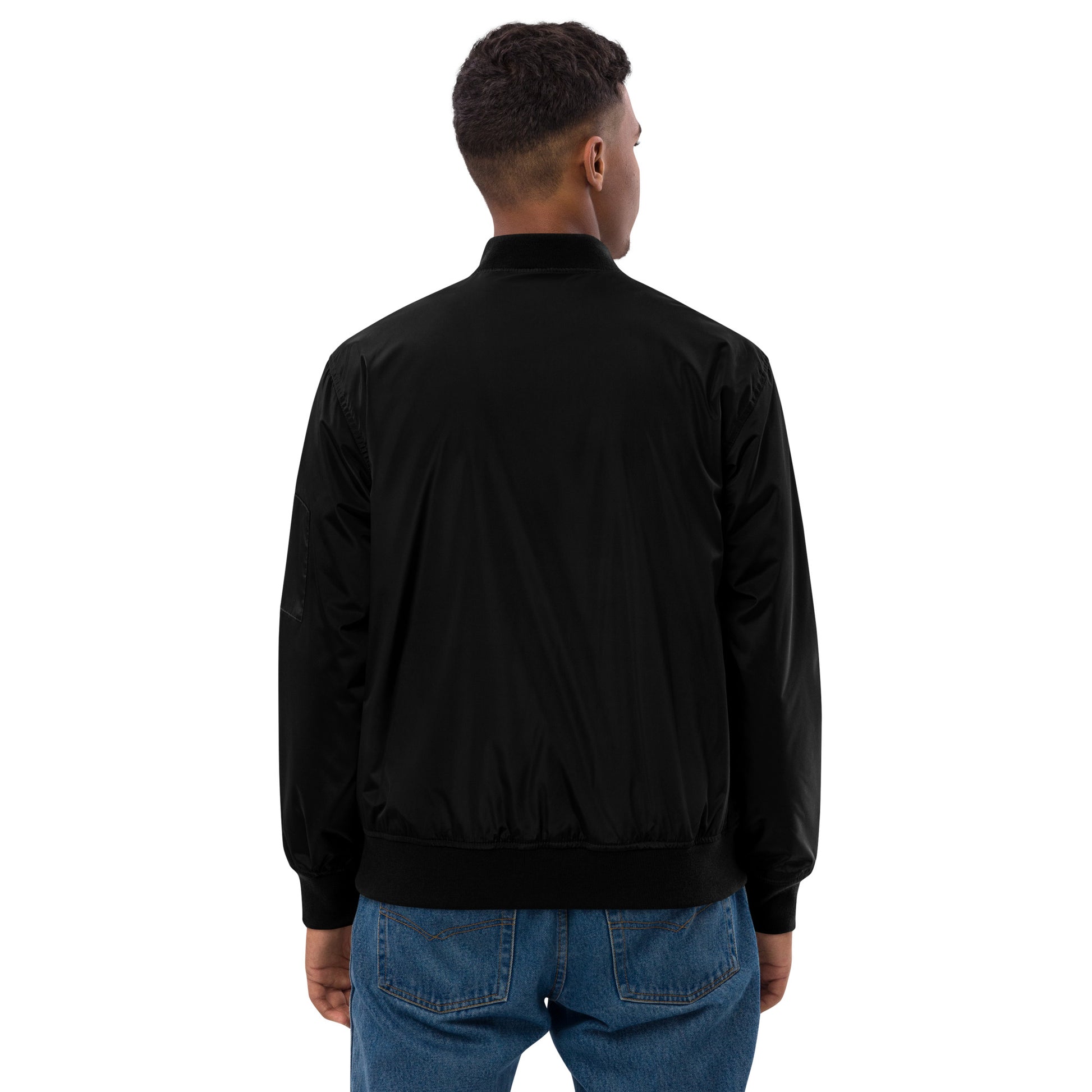 Man wearing Trizub Collection premium black recycled bomber jacket, back view, showcasing relaxed fit and sustainable design.