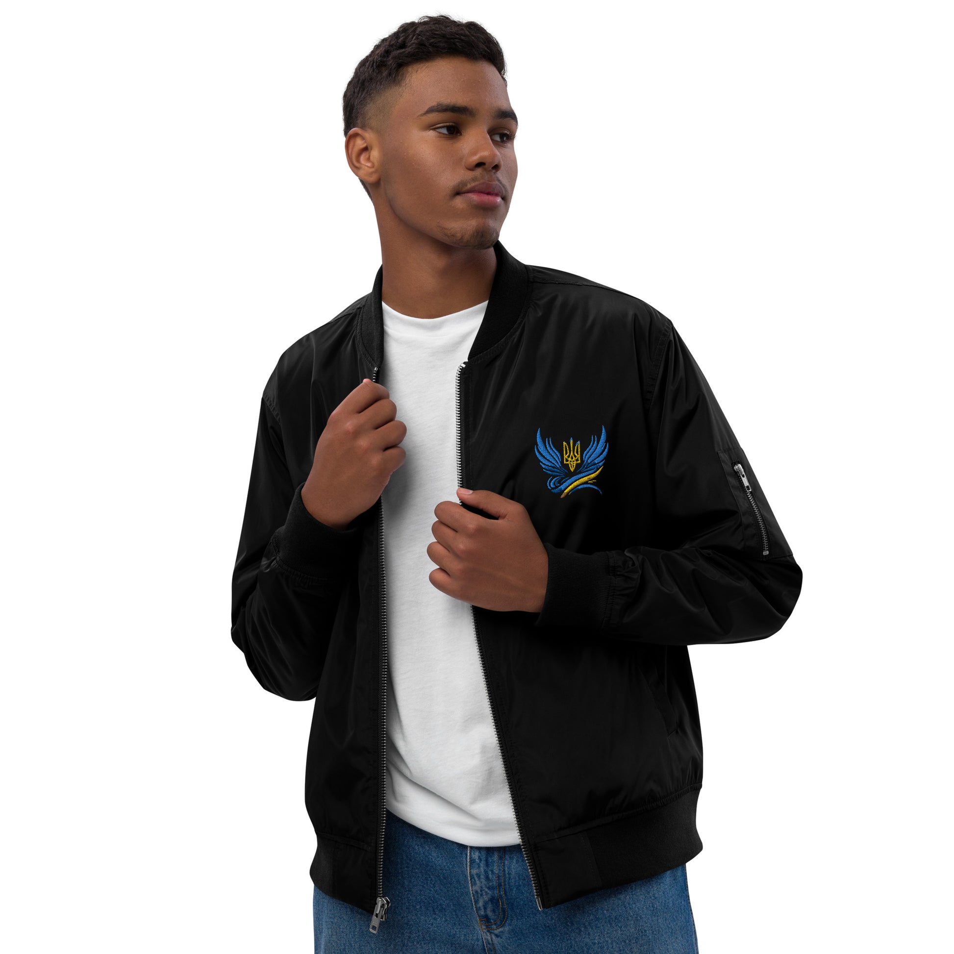 Man wearing black Trizub Collection premium recycled bomber jacket with Ukrainian emblem.