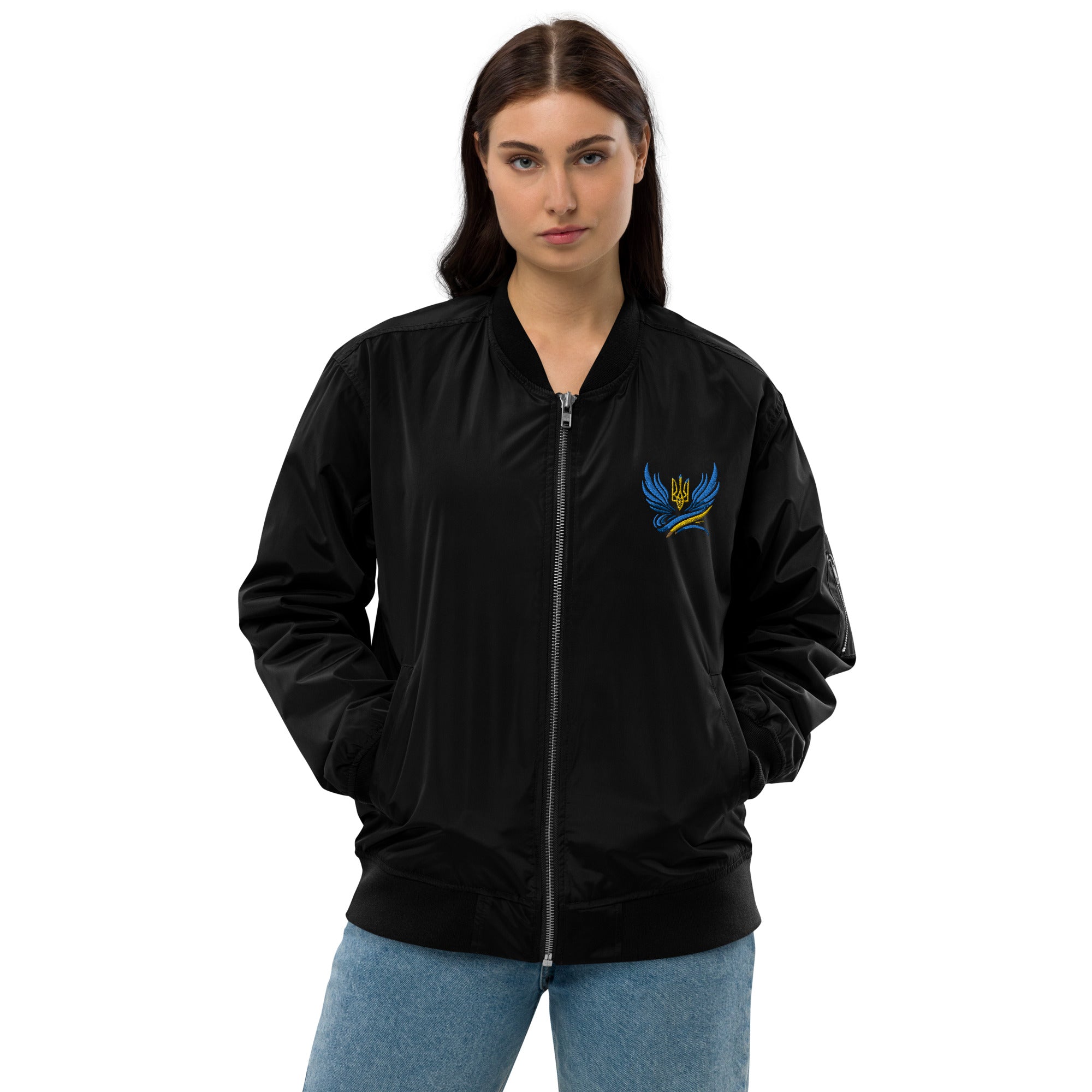 Model wearing Ukrainian Premium Recycled Bomber Jacket, black with blue Trizub emblem, eco-friendly, stylish and versatile unisex fit.