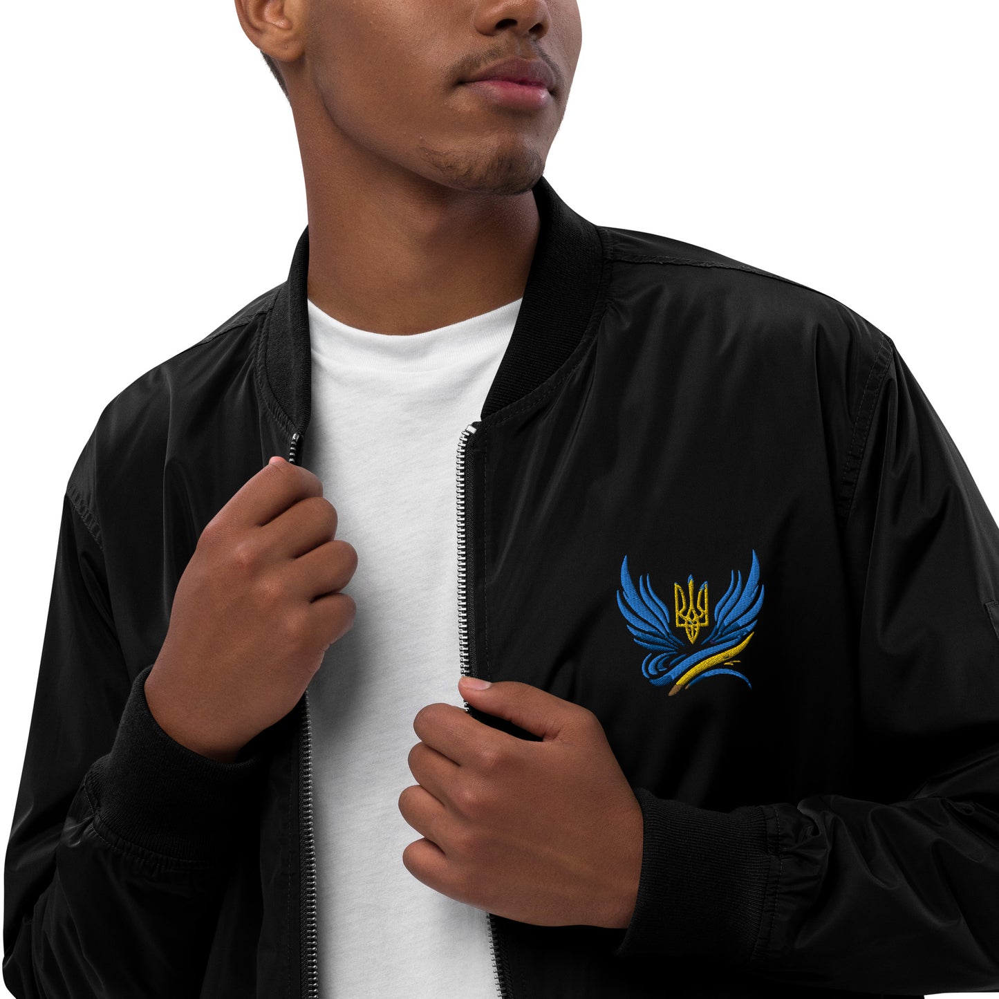 Man wearing premium recycled polyester bomber jacket from Trizub Collection with Ukrainian emblem embroidery.