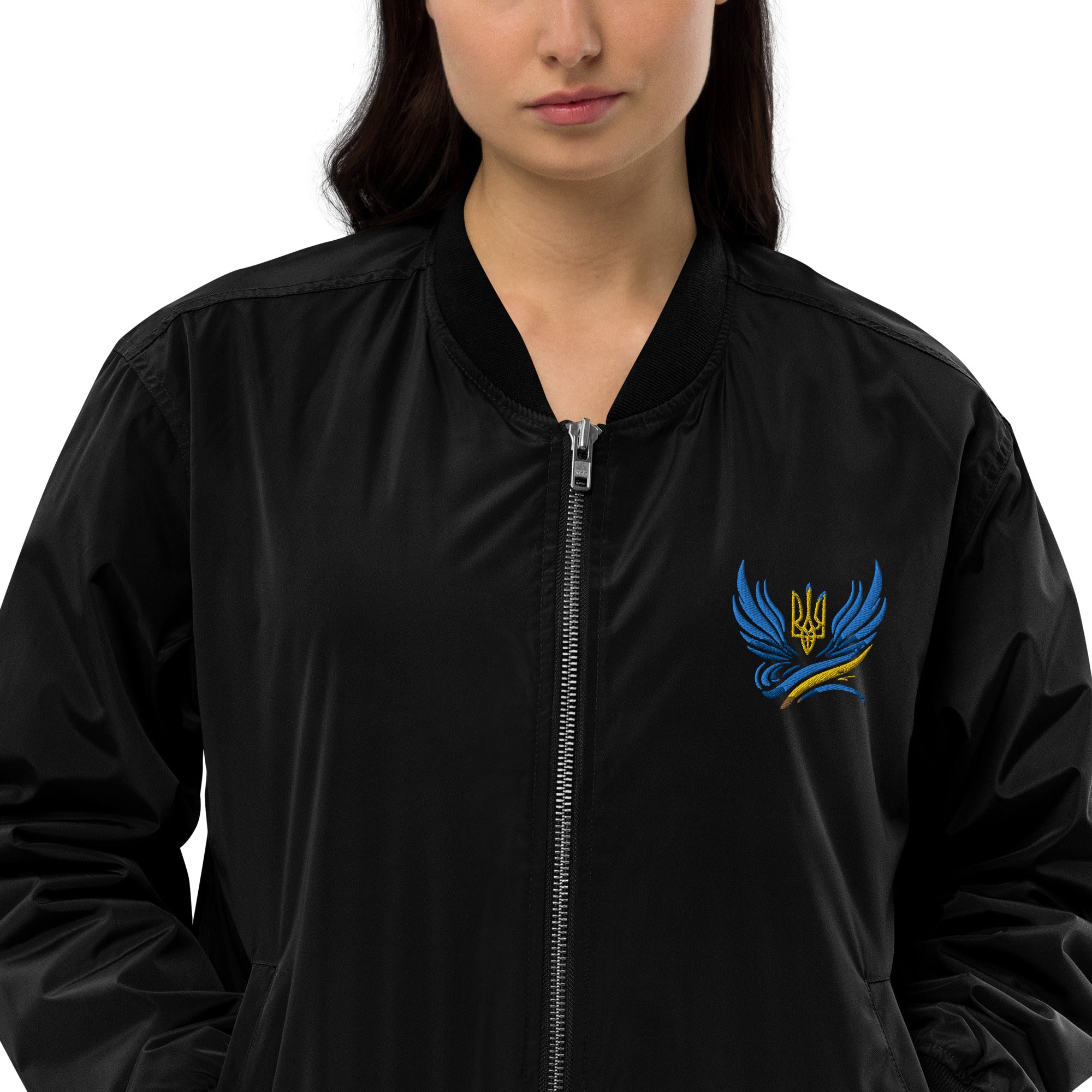 Woman wearing Ukrainian Premium Recycled Bomber Jacket with Trizub logo, made from 100% recycled polyester. Eco-friendly fashion.