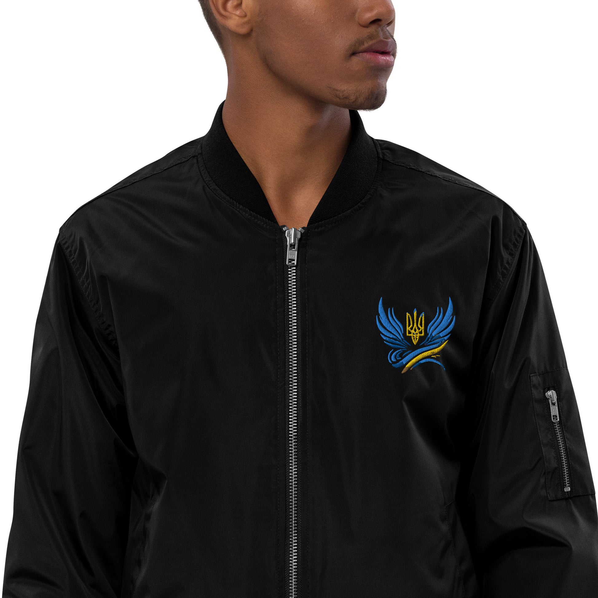 Man wearing Trizub Collection recycled bomber jacket with Ukrainian emblem design.