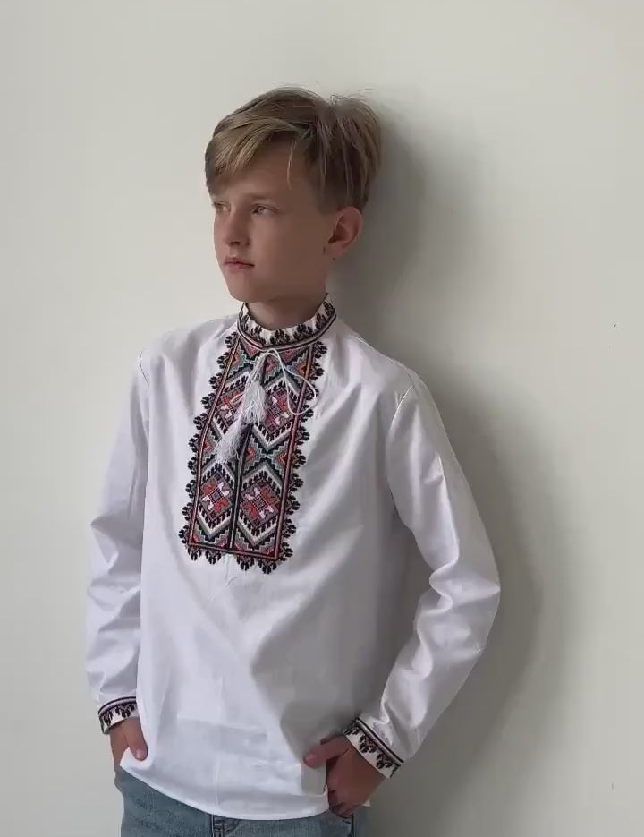 Boy wearing handmade boys’ cotton Vyshyvanka, traditional Ukrainian embroidered shirt with cross-stitch design. Perfect for cultural events.