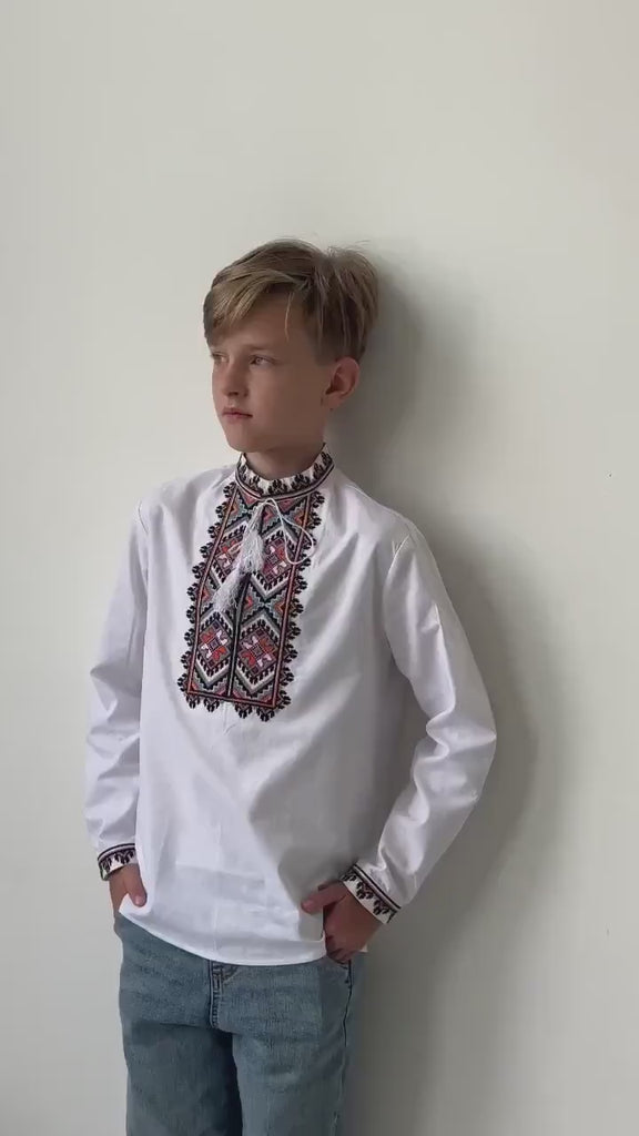 Boy wearing handmade boys’ cotton Vyshyvanka, traditional Ukrainian embroidered shirt with cross-stitch design. Perfect for cultural events.