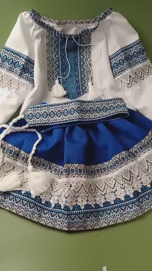 Ukrainian Hutsul folk costume for girls in blue with white lace; includes blouse, skirt, and woven belt. Ideal for cultural events.