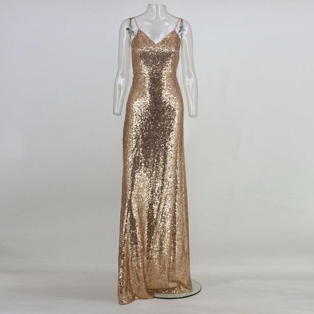 Gold sequin backless evening gown on mannequin, featuring spaghetti straps and a floor-length design for glamorous events.