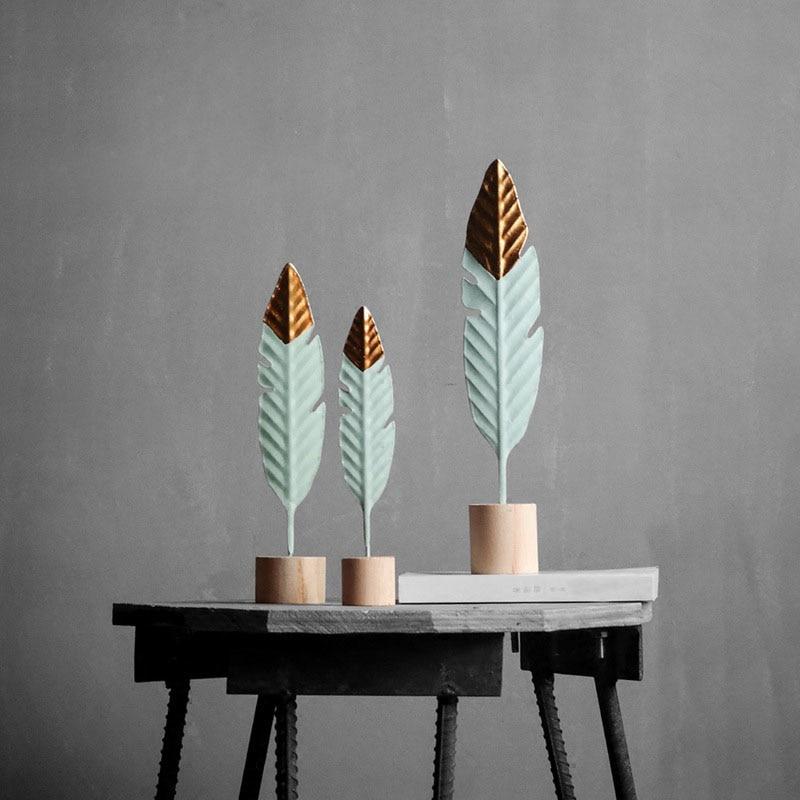 Ezven handcrafted feather-inspired wooden figurines in varying sizes, perfect for adding elegance to modern interiors with their warm wood grain.