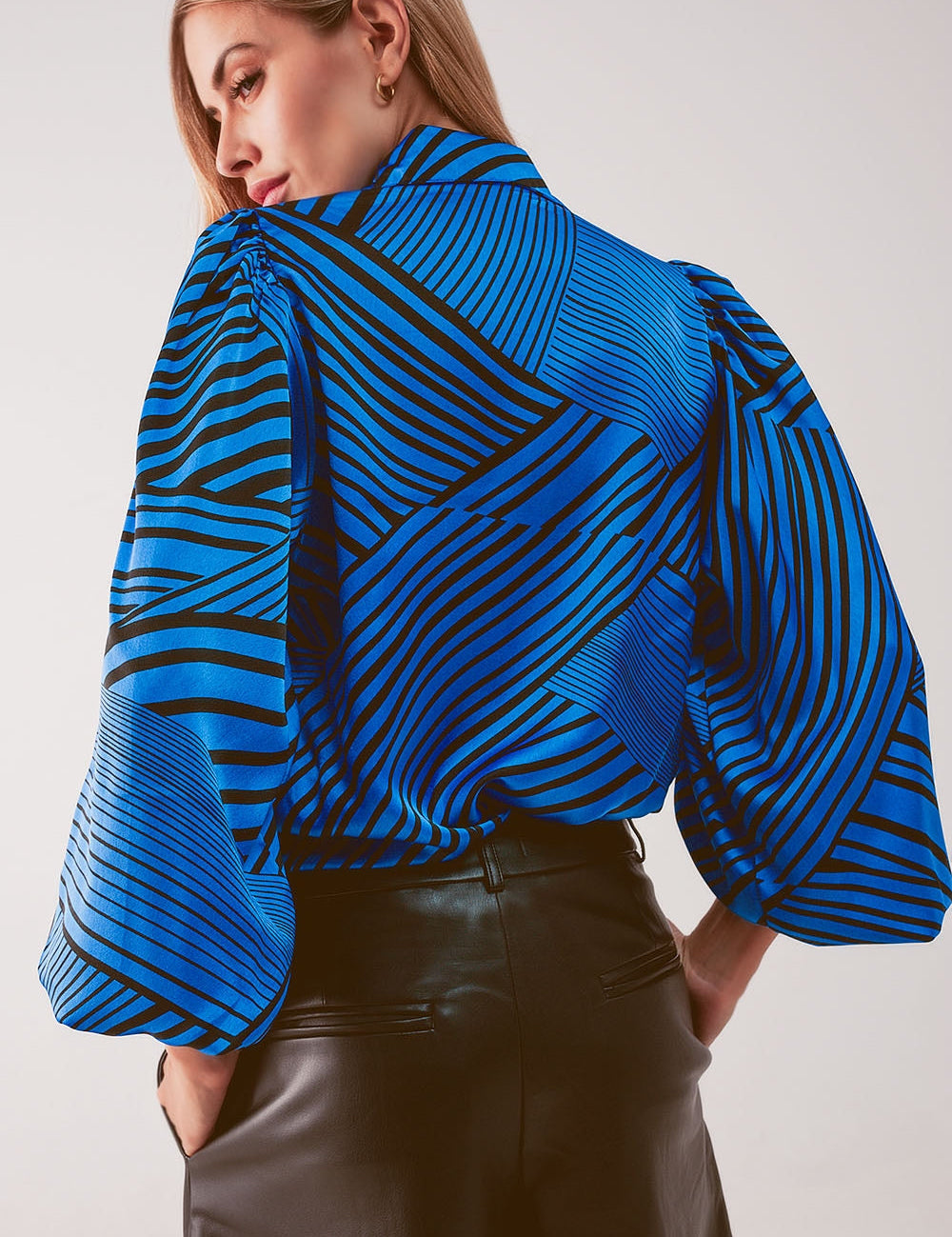 Woman wearing Zorellia Striped Puff Sleeve Blouse in blue tones, showcasing vintage-inspired design and modern tailoring.