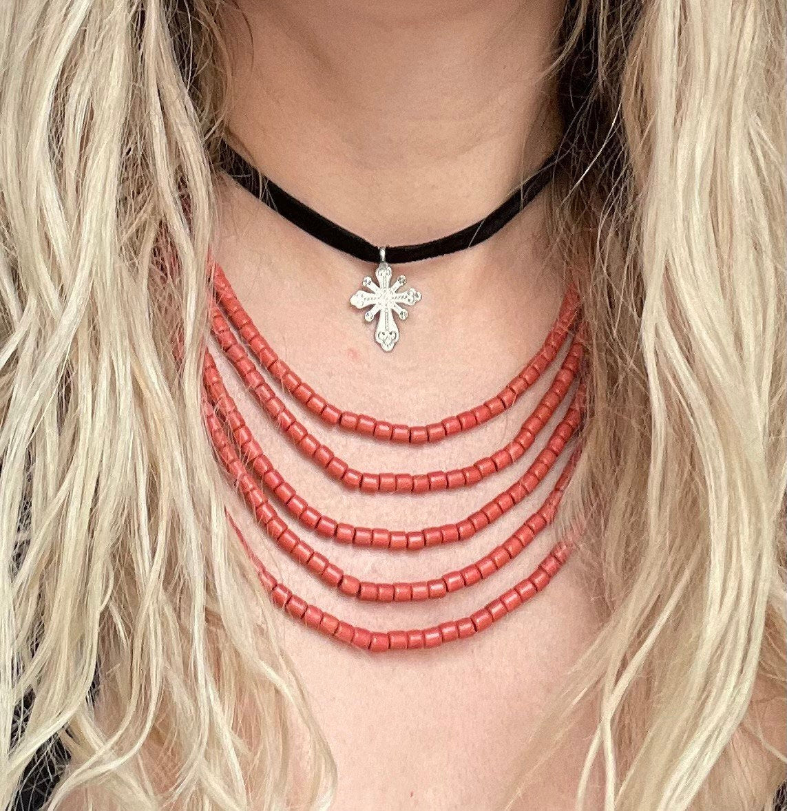 Red ceramic beaded necklace, handmade Ukrainian ethnic jewelry, Scythian-inspired, worn with black cord and silver pendant.