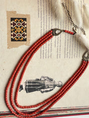 Red ceramic beaded necklace on a vintage Ukrainian folk background, showcasing handmade ethnic Hutsul jewelry.
