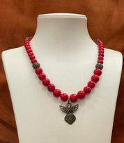 Hutsul handmade red coral bead necklace with angel pendant on white display, Ukrainian ethnic jewelry gift for her.