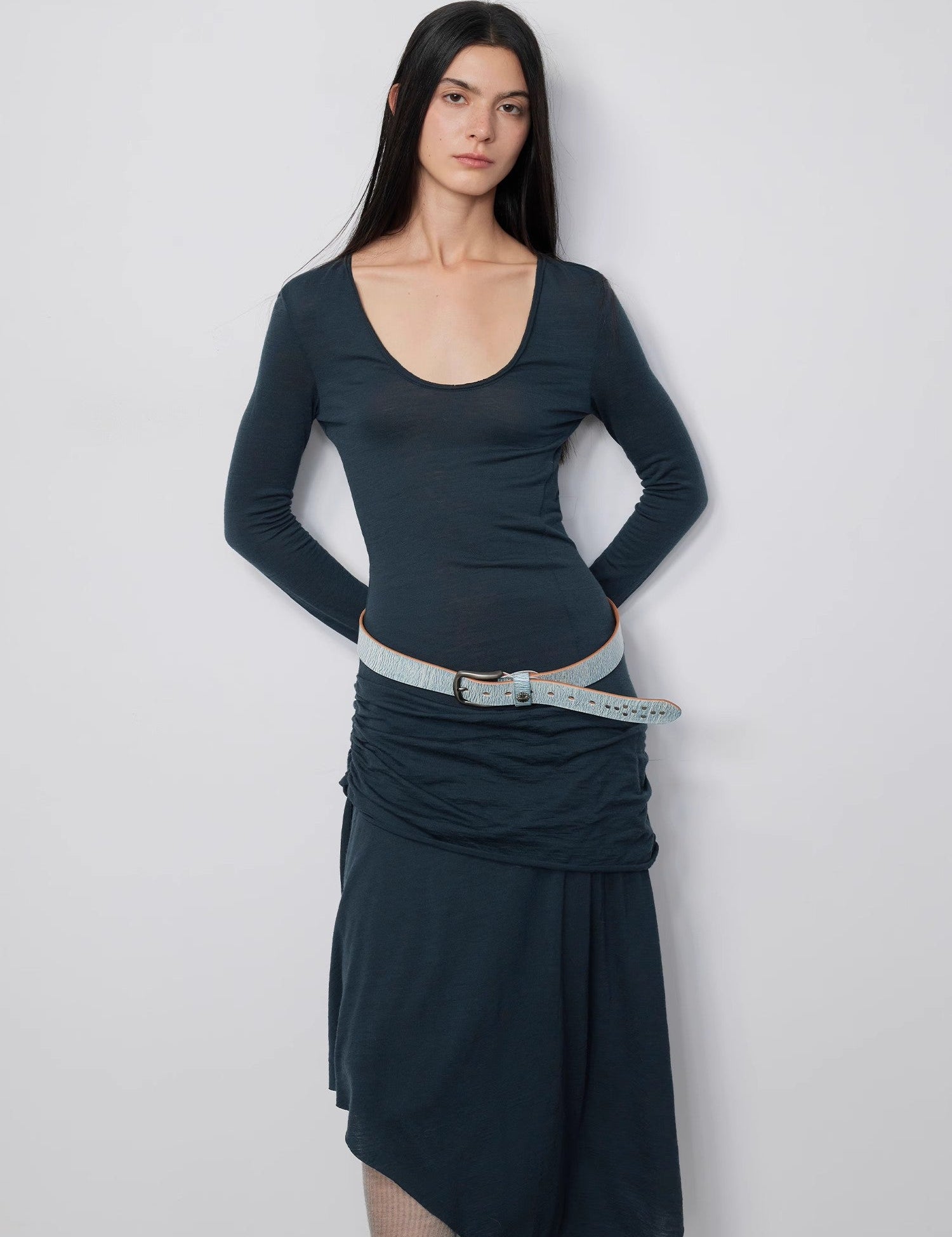 Model wearing Serelis Merino Wool Drape Dress with U-neck, tailored waist, and ankle-skimming hem in blue tonal design.