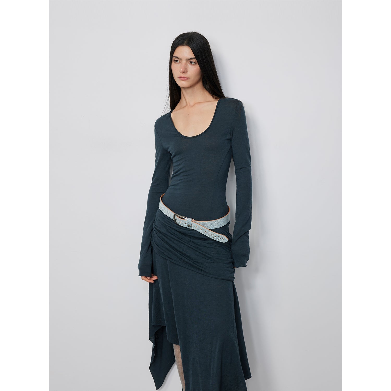 Woman wearing Serelis Merino Wool Drape Dress with U-neck and tailored waist, showcasing elegant lines and flowing skirt.