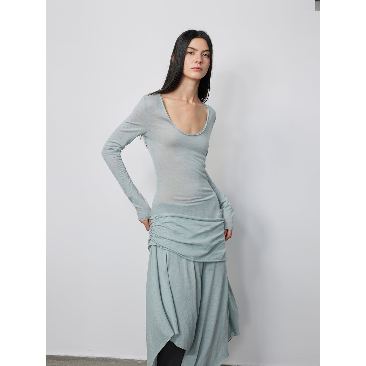 Serelis Merino Wool Drape Dress showcasing elegant design with tailored waist and flowing skirt.