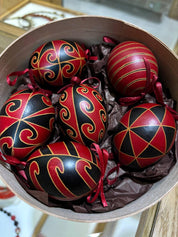 Hand-painted set of 6 Ukrainian Pysanky eggs with intricate folk designs in a decorative box, traditional Easter art gift.