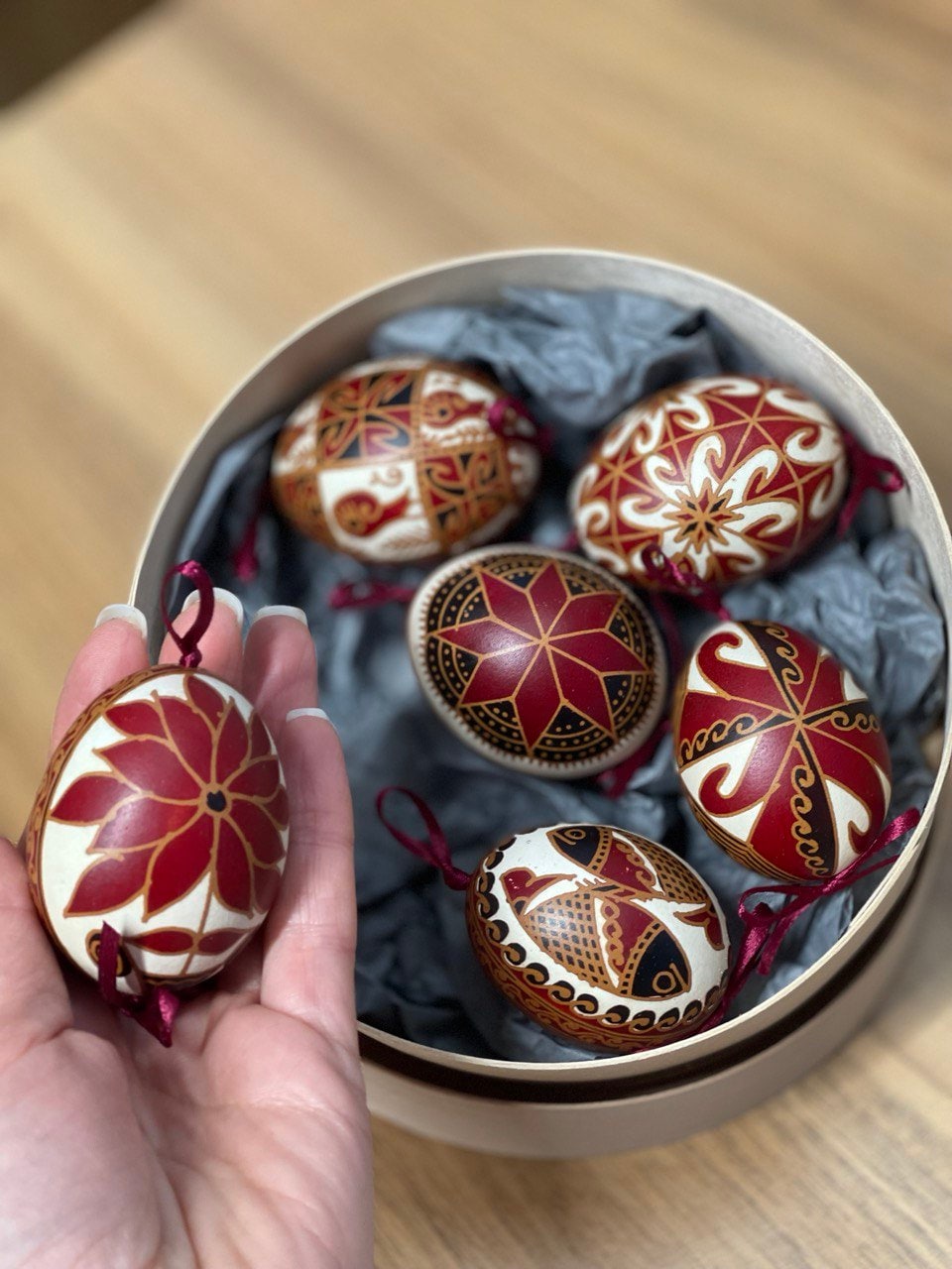 Set of 6 handmade Ukrainian Pysanky eggs with traditional designs in a box, perfect for Easter or Christmas gifts.