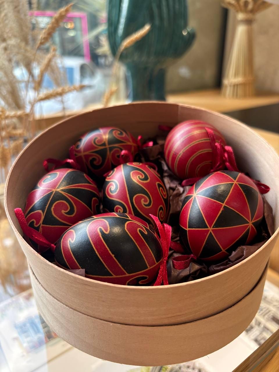 Set of 6 hand-painted Ukrainian Pysanky eggs in a gift box, featuring black and red traditional folk art designs.