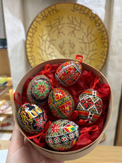 Set of 6 hand-painted Ukrainian Pysanky Easter eggs in a decorative box, showcasing vibrant traditional folk designs.
