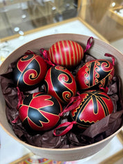 Set of 6 handmade Ukrainian Pysanky in a bowl, featuring red and black traditional folk art designs on real chicken eggs.