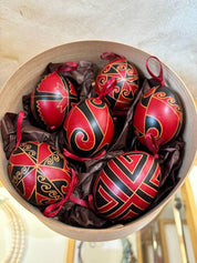 Set of 6 hand-painted Ukrainian Pysanky eggs in a decorative box, showcasing traditional folk art using the beeswax-resist technique.