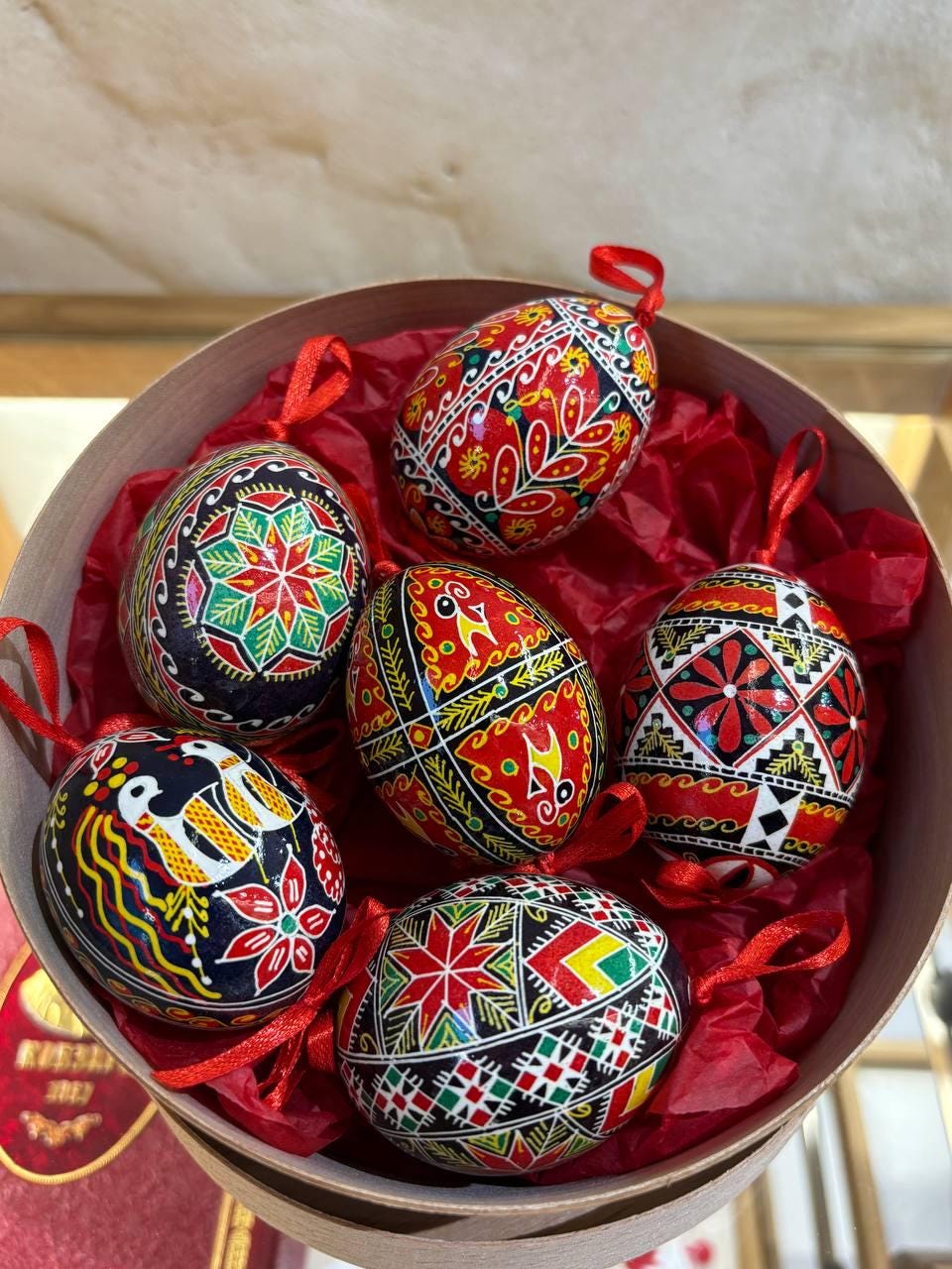 Set of 6 hand-painted Ukrainian Pysanky Easter eggs in a box, crafted from real chicken eggshells with traditional folk designs.