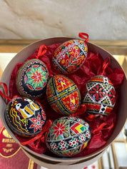 Set of 6 hand-painted Ukrainian Pysanky Easter eggs in a box, crafted from real chicken eggshells with traditional folk designs.