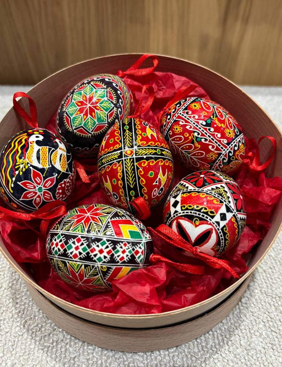 Set of 6 hand-painted Ukrainian Pysanky Easter eggs in vibrant traditional patterns, displayed in a decorative box.