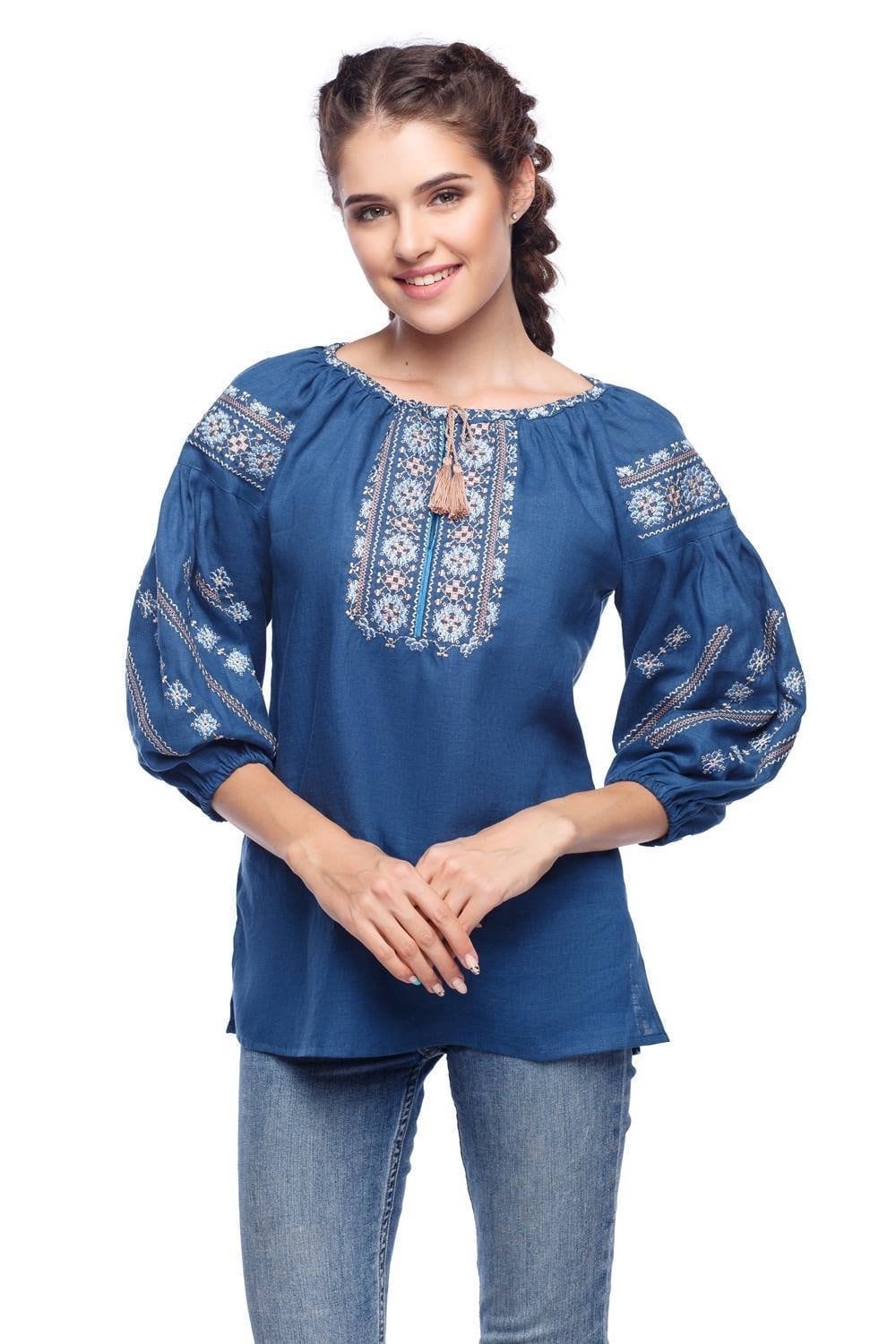 Sky blue linen embroidered blouse with Ukrainian vyshyvanka design, showcased by model. Ethnic style, women's fashion.