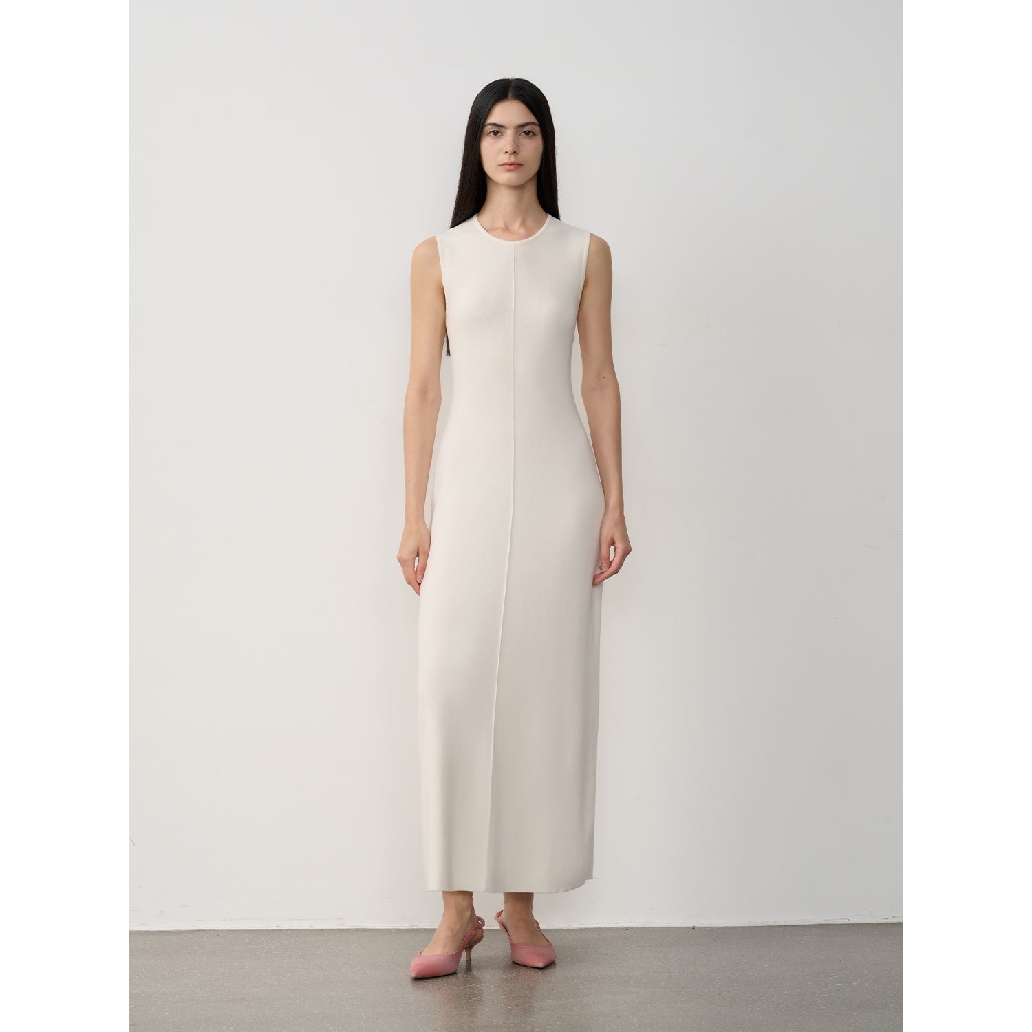 Woman wearing Solenne Merino Wool Maxi Knit Dress, minimalist sleeveless design, ankle-length, ivory color
