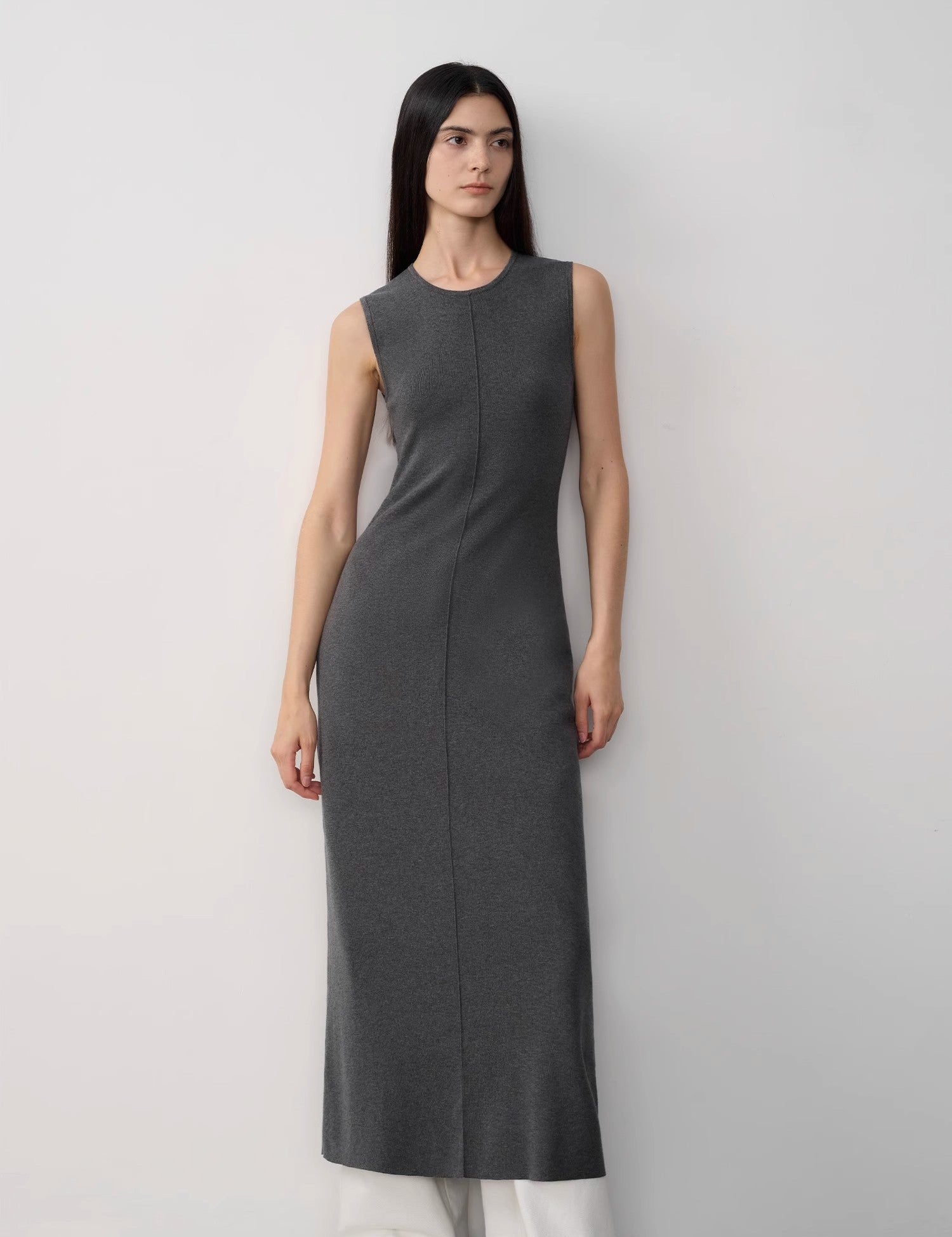 Solenne Merino Wool Maxi Knit Dress with minimalist sleeveless design, central seam, and ankle-length cut for elegance and comfort.