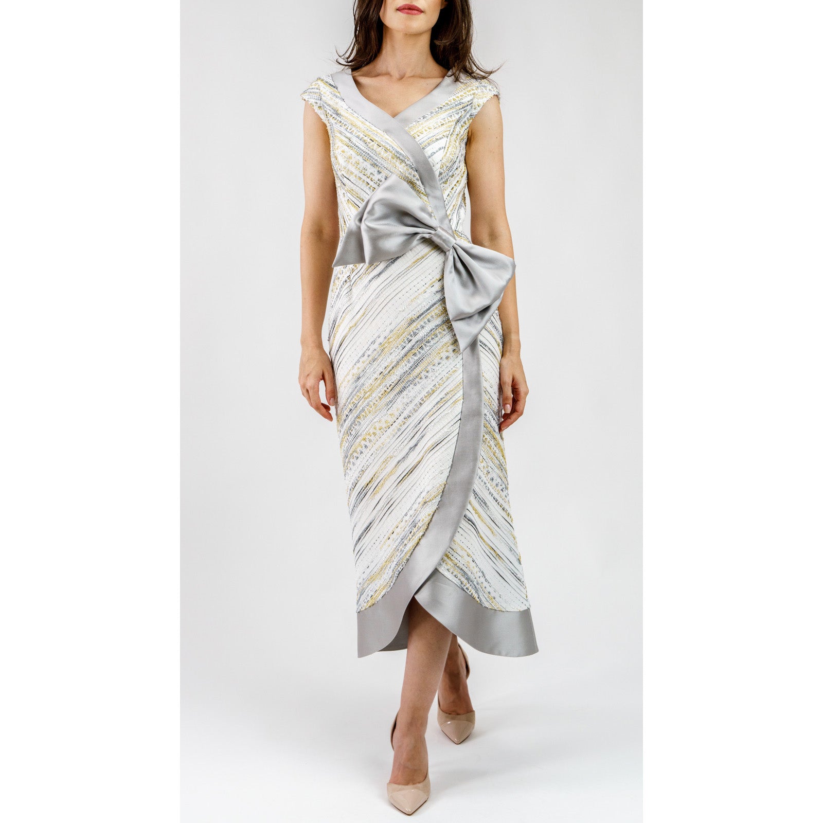 Woman wearing Celestienne Metallic Jacquard Cocktail Dress with silver bow, V-neckline, and artful butterfly-inspired design.