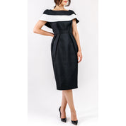 Woman wearing Marcelline Contrast-Collar Midi Dress with black and white neckline, highlighting sculpted bodice and French jacquard fabric.