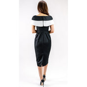 Rear view of a woman wearing a Marcelline Contrast-Collar Midi Dress, featuring a black and white neckline and shimmering French jacquard.