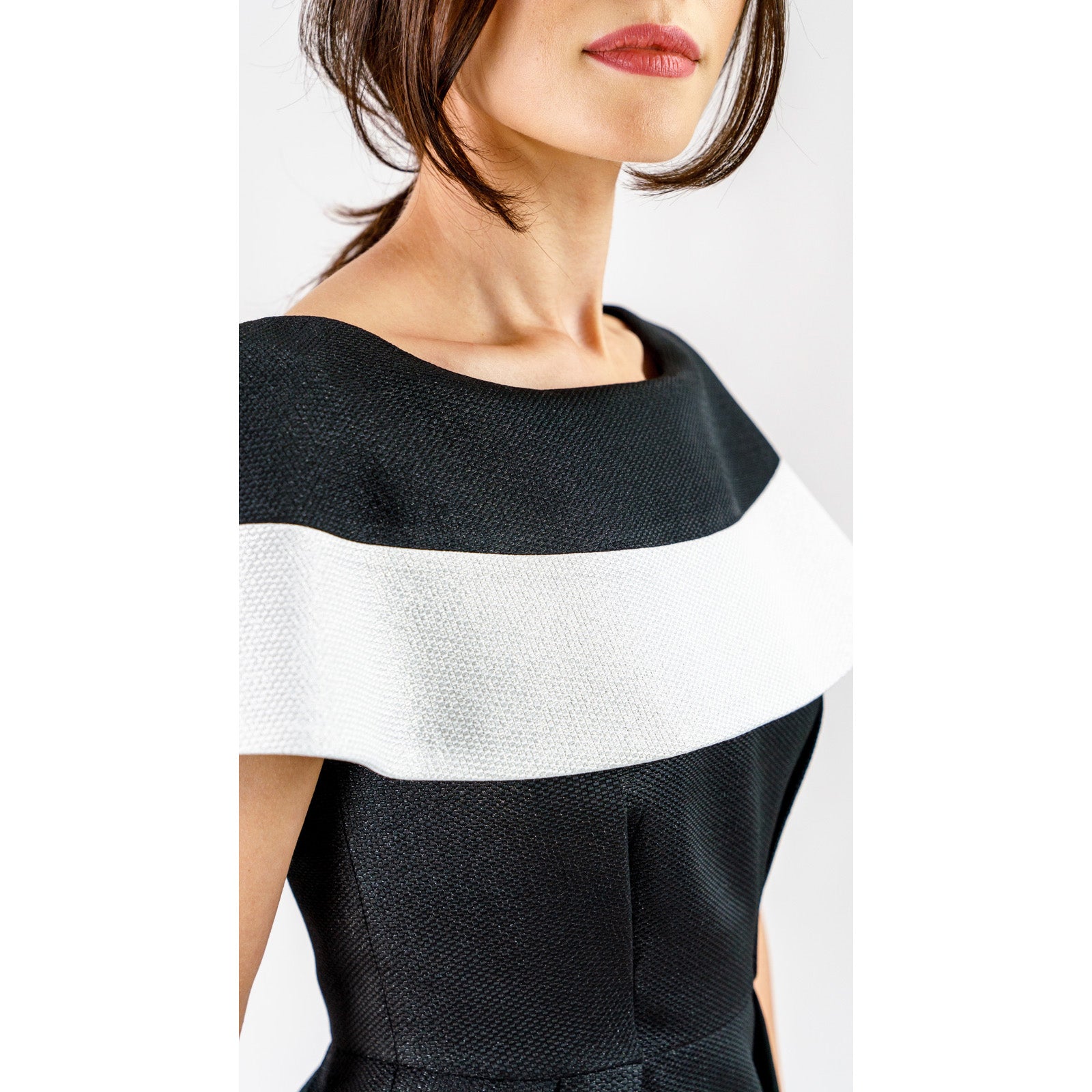 Marcelline contrast-collar midi dress in black and white, featuring a sculpted bodice and modern neckline in shimmering French jacquard.