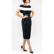 Woman wearing Marcelline Contrast-Collar Midi Dress, featuring black-and-white neckline and vintage-inspired tailored fit.