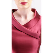 Close-up of woman wearing Leonelle Mikado Asymmetric Collar Dress in pearlescent red mikado fabric, showcasing dramatic collar design.