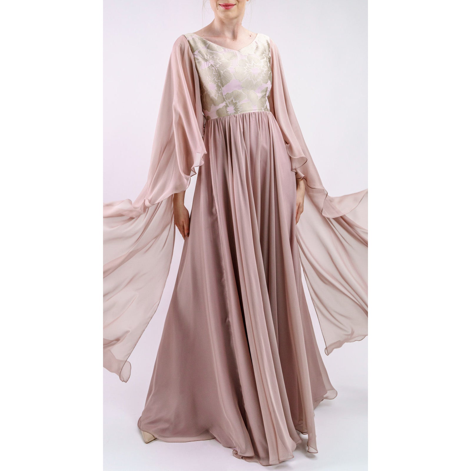 Elisara Blush Embroidered Evening Gown with floral organza top and flowing sleeves, highlighting a romantic and elegant silhouette.