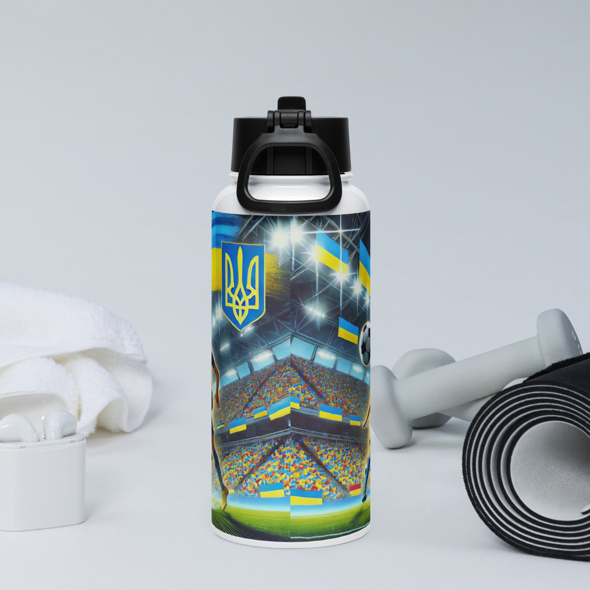 Steel water bottle with Ukrainian soccer emblem and vacuum insulation, shown with gym accessories for hydration and support.