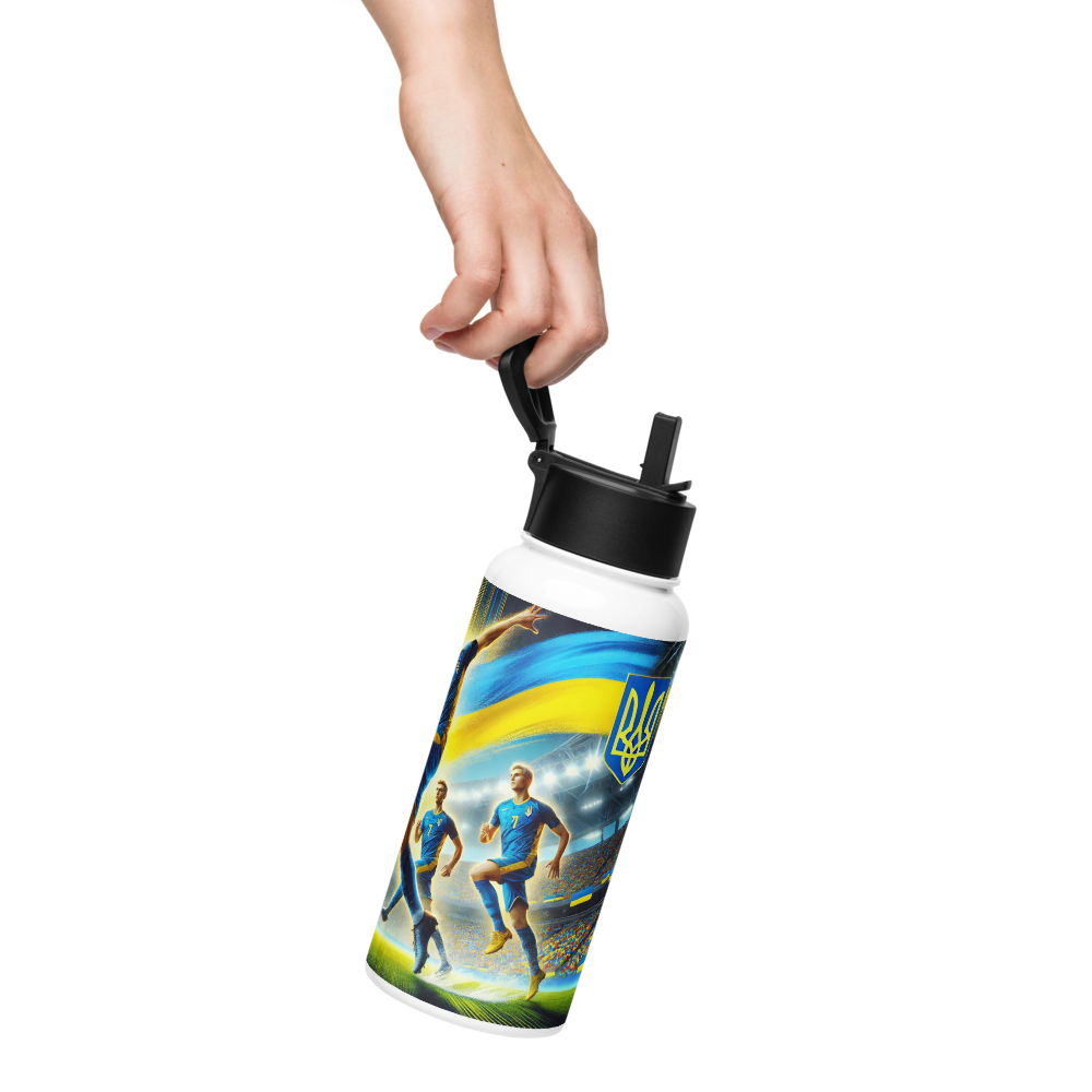 Hand holding a 32 oz steel water bottle featuring Ukrainian soccer emblem and athletes, perfect for supporting the national team.
