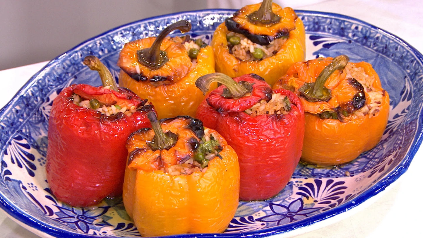 Plate of homemade Ukrainian stuffed peppers with rice and meat filling, showcasing vibrant red and yellow bell peppers.