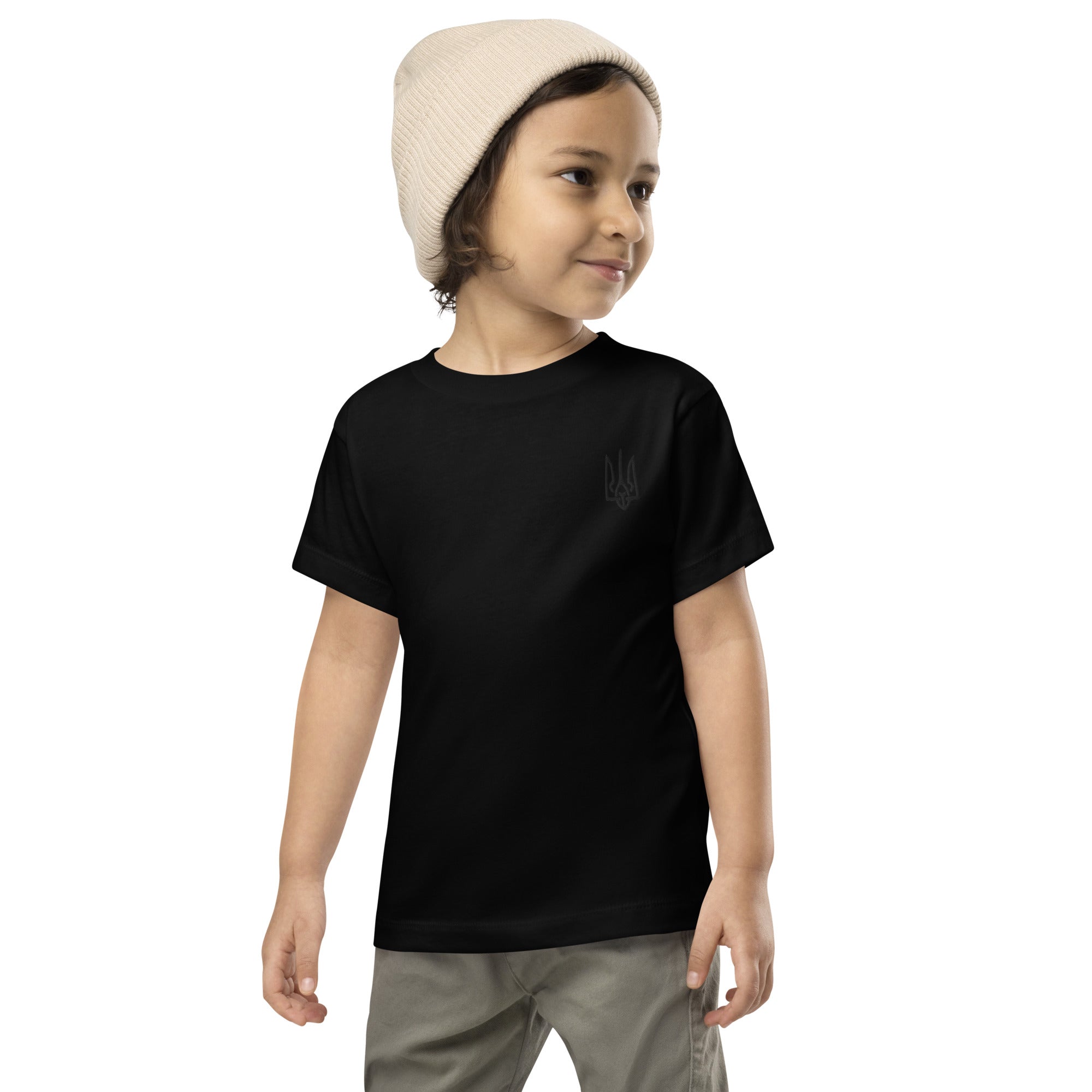 Toddler wearing a black short sleeve tee with Ukrainian Tryzub print, made from 100% cotton for comfort and style.