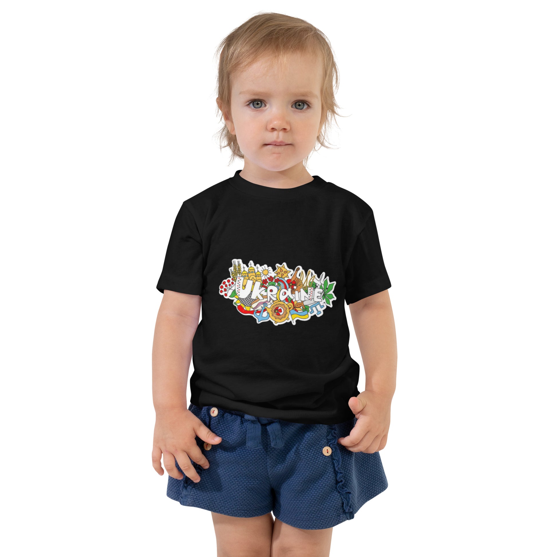 Toddler wearing a black short sleeve t-shirt with a colorful Ukraine design, showcasing cultural pride and style.